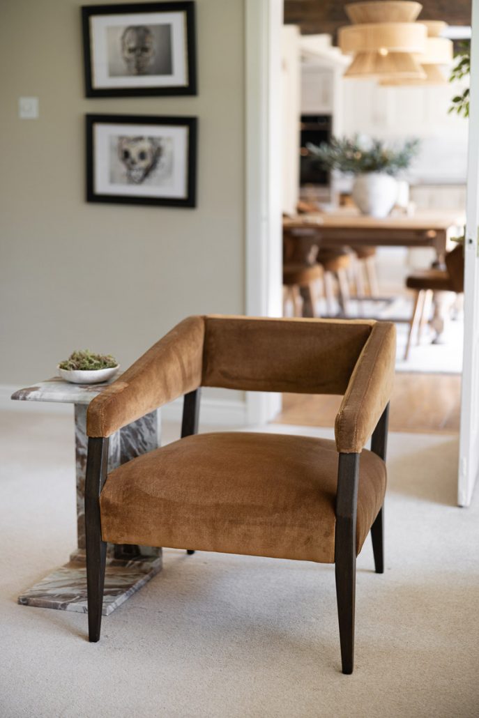 close-up of soft brown velvet chair and wooden table.