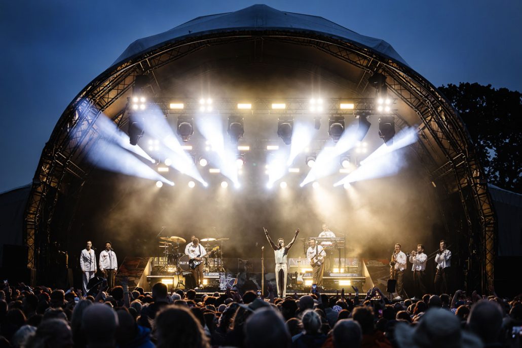 Olly Murs performing live on stage at Cartmel Racecourse concert with full band and lighting show
