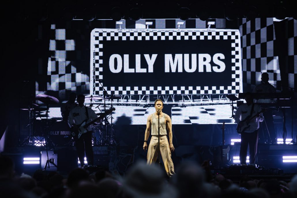 Olly Murs performing live on stage at Cartmel Racecourse concert with full band and lighting show