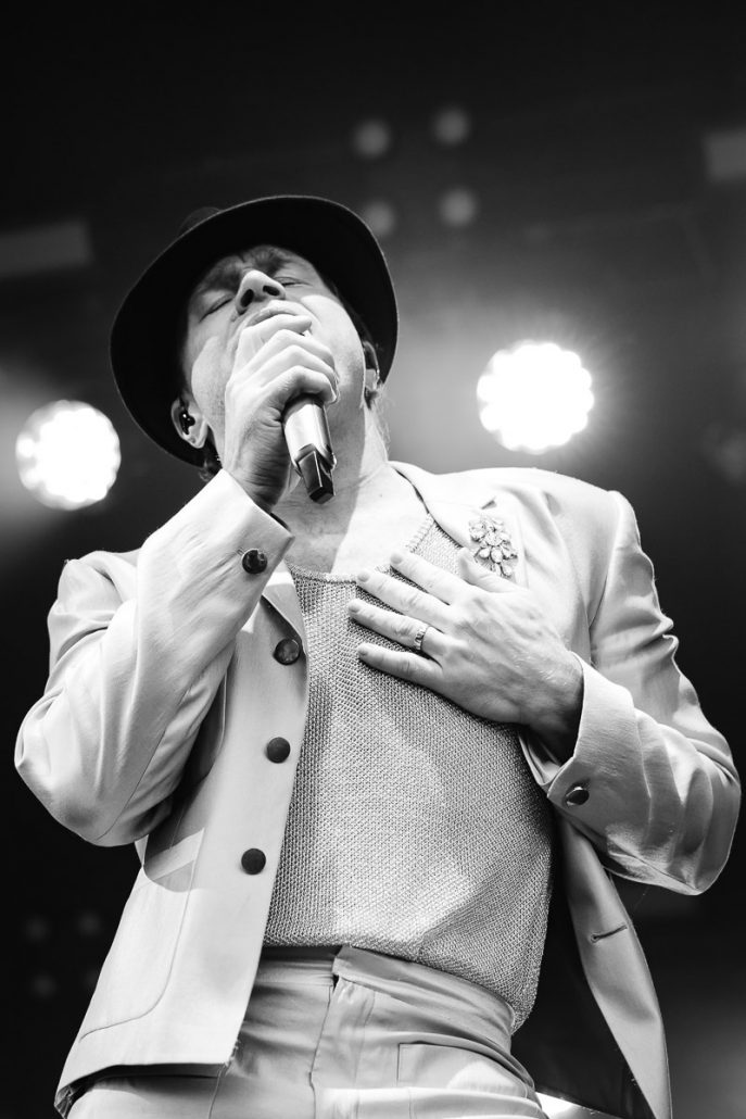 Olly Murs performing live on stage at Cartmel Racecourse concert with full band and lighting show