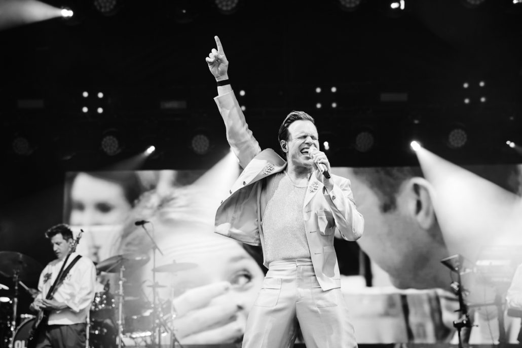 Olly Murs performing live on stage at Cartmel Racecourse concert with full band and lighting show