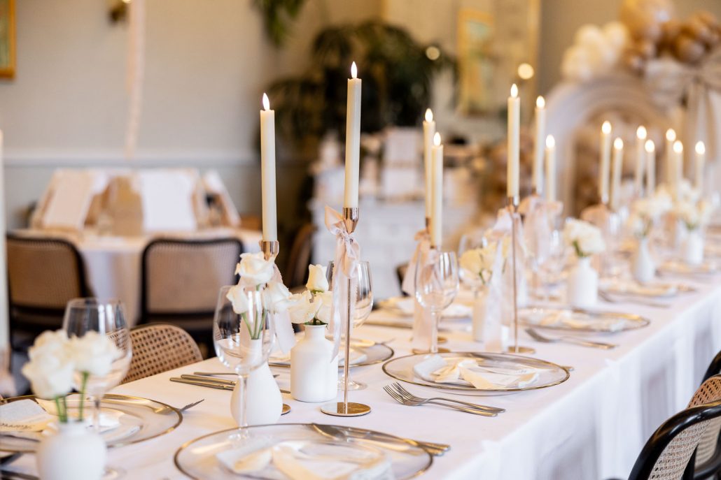Long table with candles and balloon backdrop