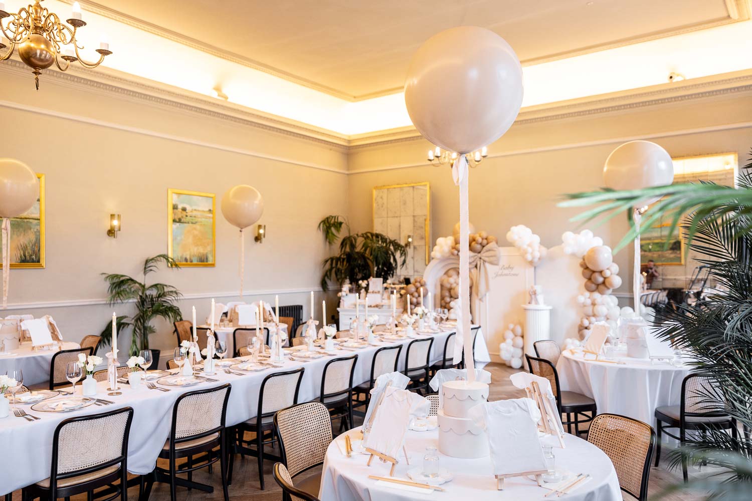 Long table with candles and balloon backdrop