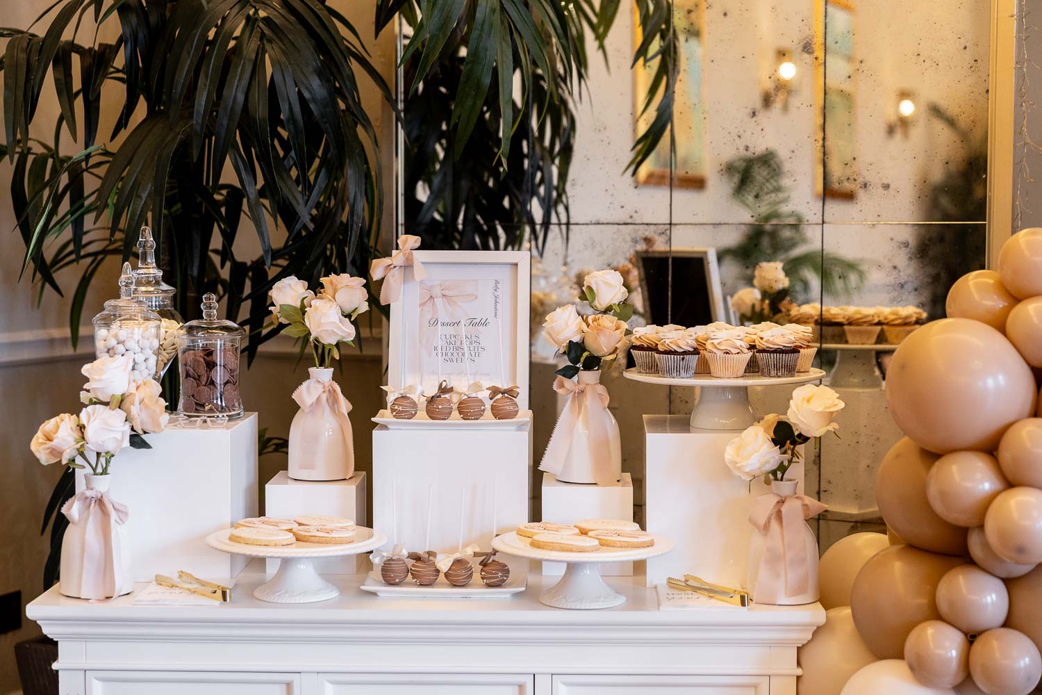 Dessert table with sweets and roses