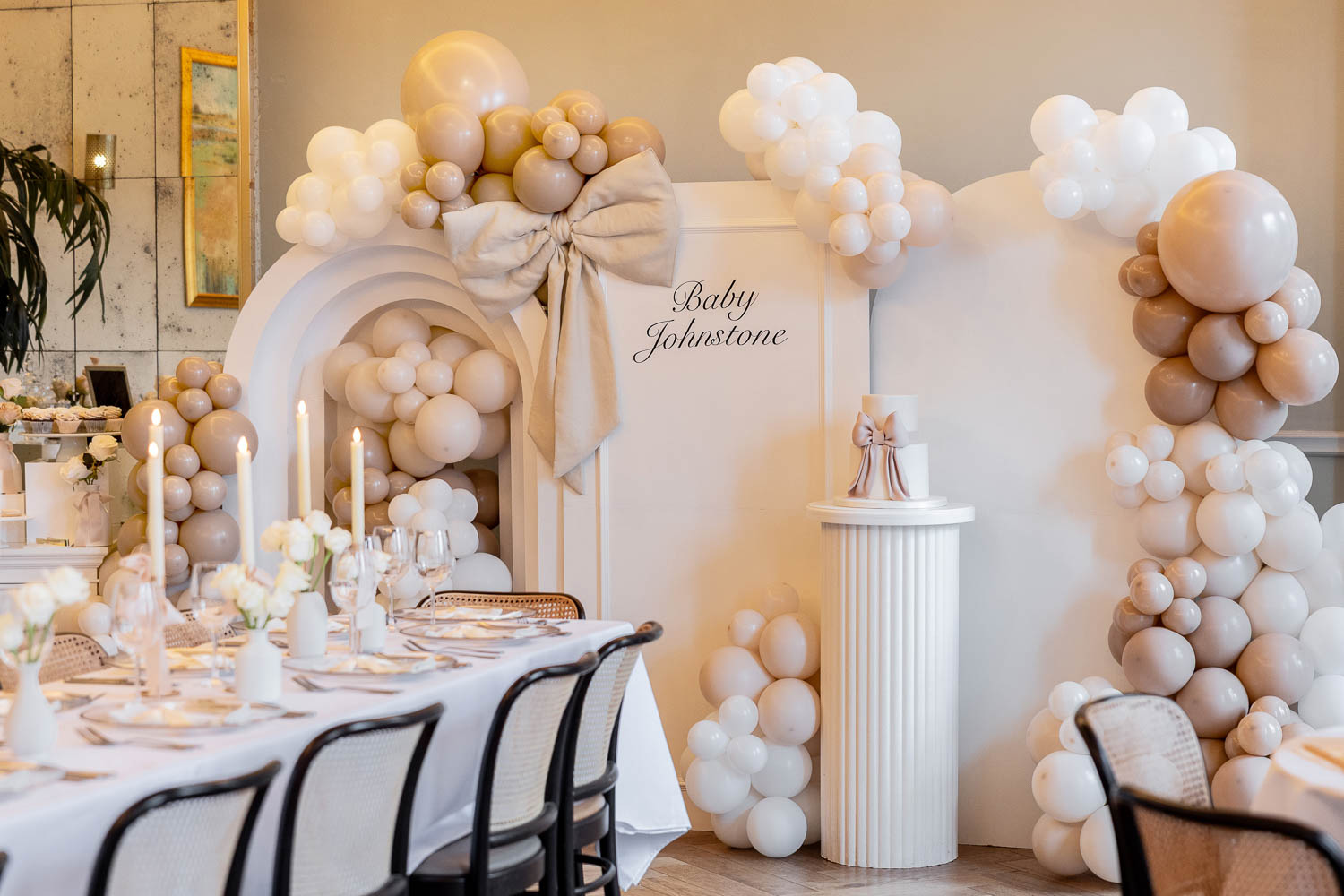 Long table with candles and balloon backdrop