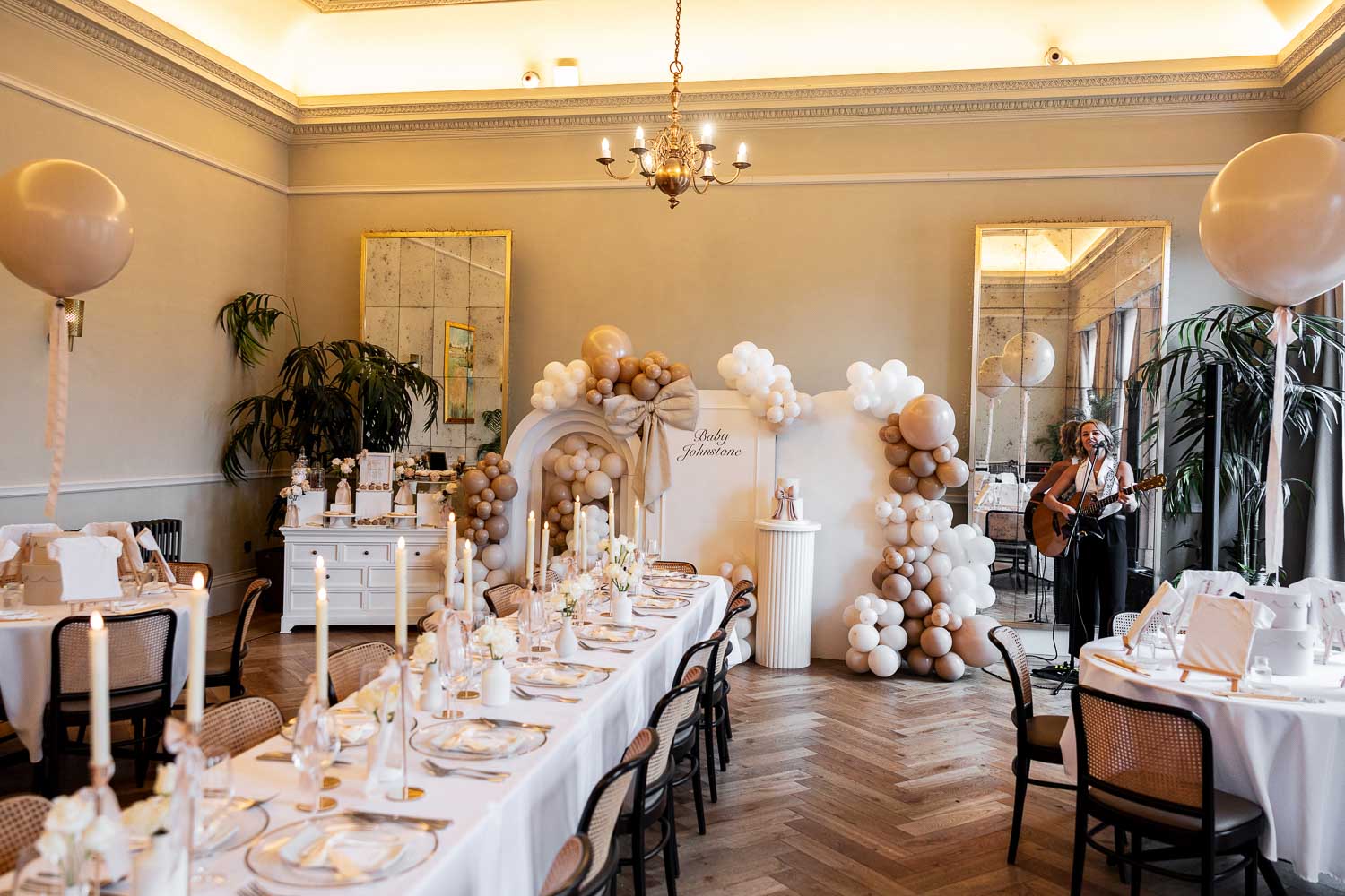 Long table with candles and balloon backdrop