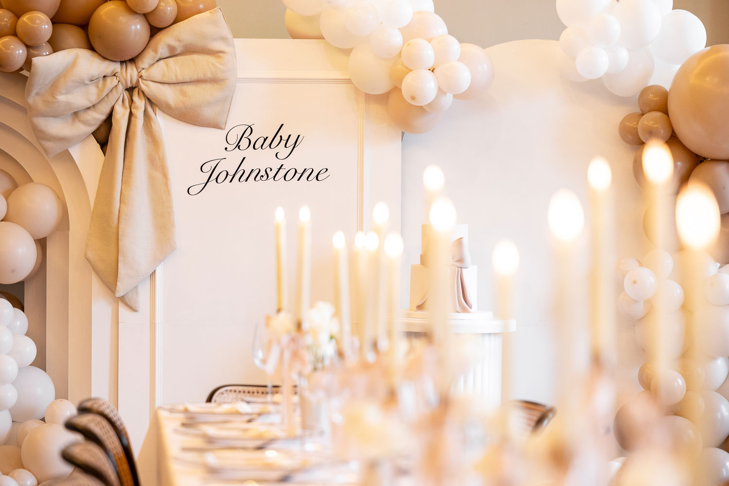 Long table with candles and balloon backdrop