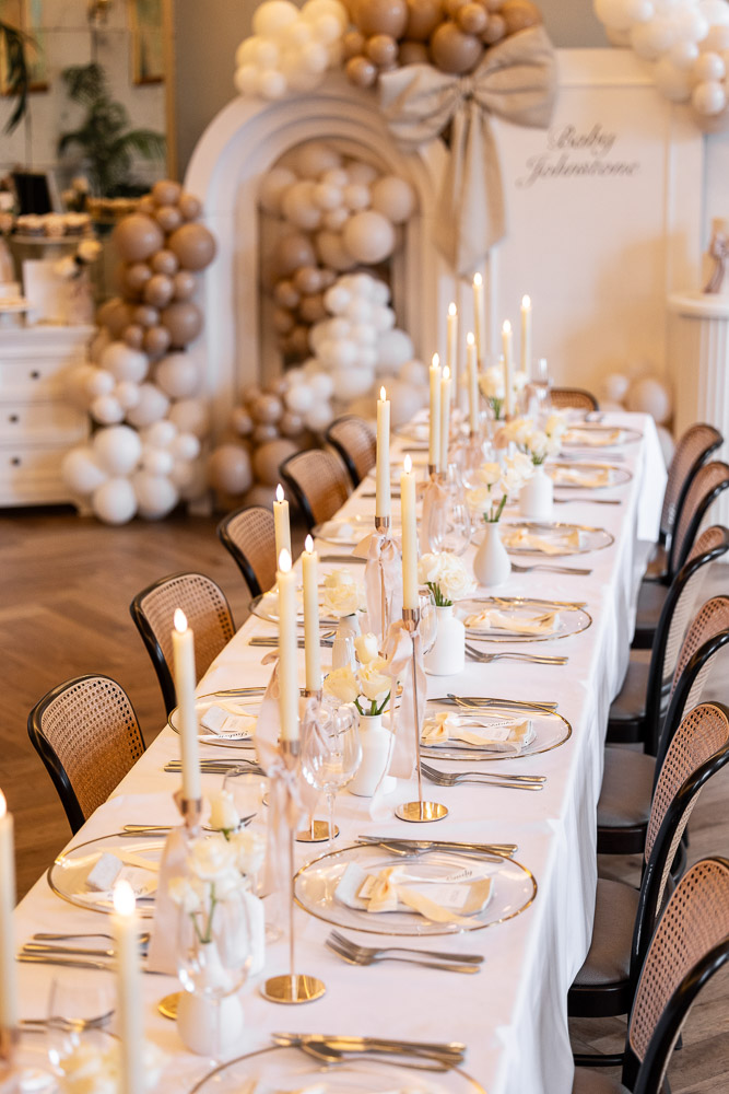 Long table with candles and balloon backdrop