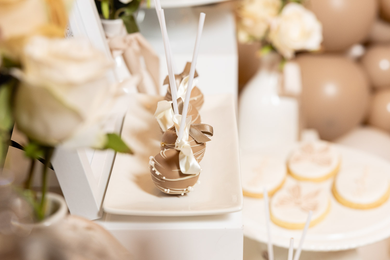 Dessert table with sweets and roses