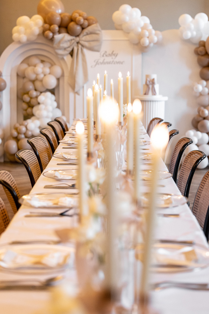 Long table with candles and balloon backdrop