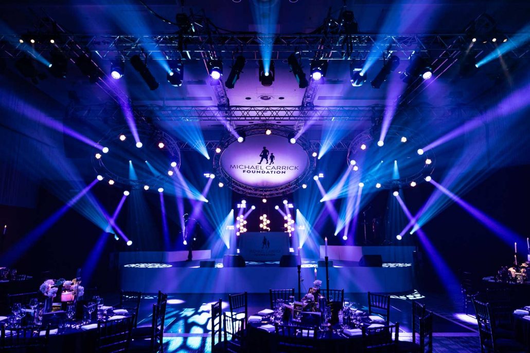 Wide stage view with dramatic purple and blue lighting