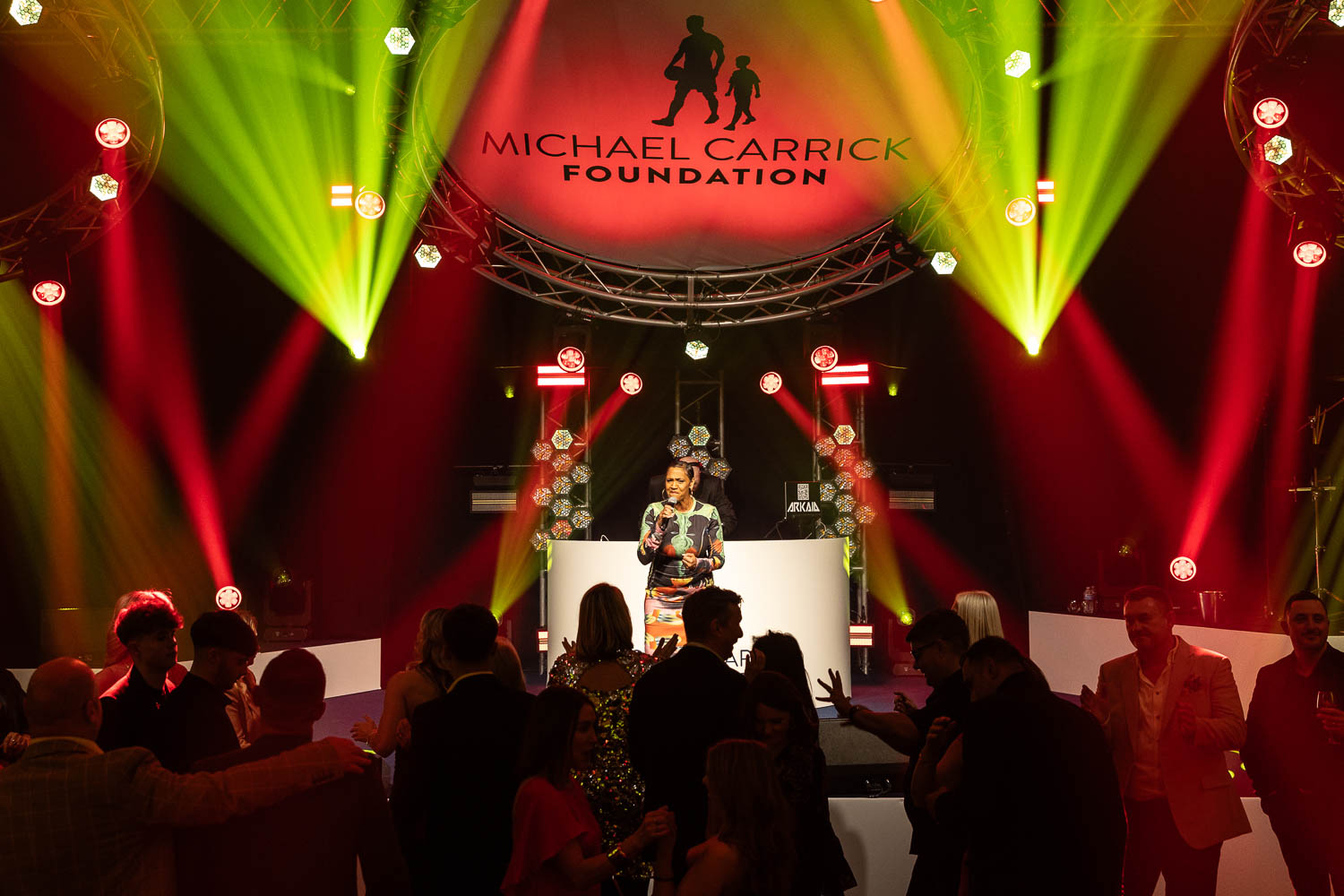 julie mcknight entertaining the guests at a charity dinner