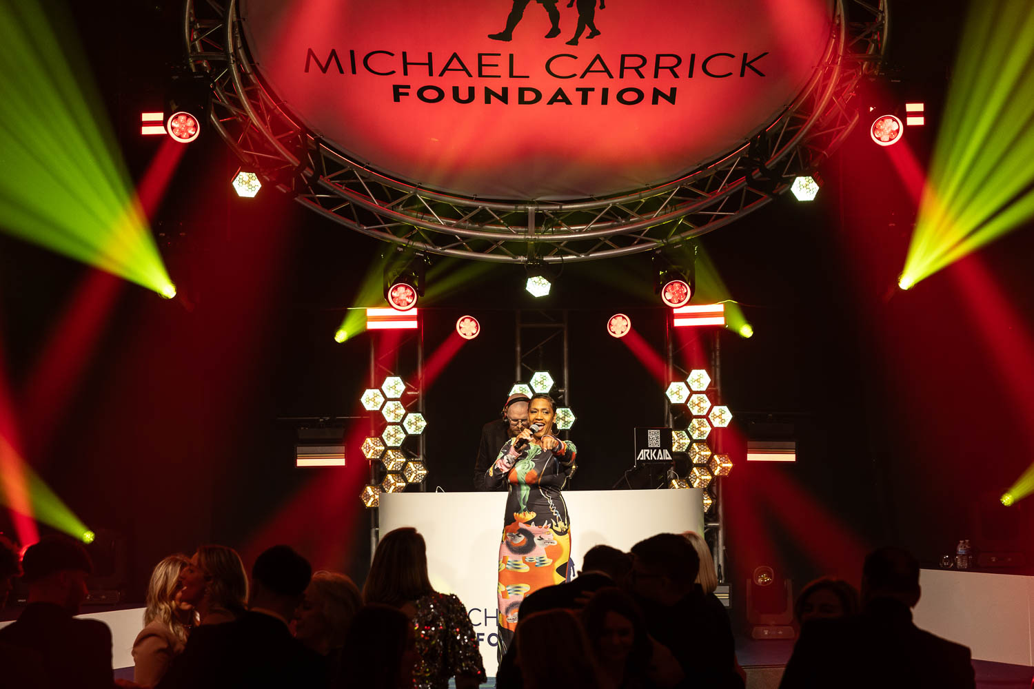 julie mcknight entertaining the guests at a charity dinner