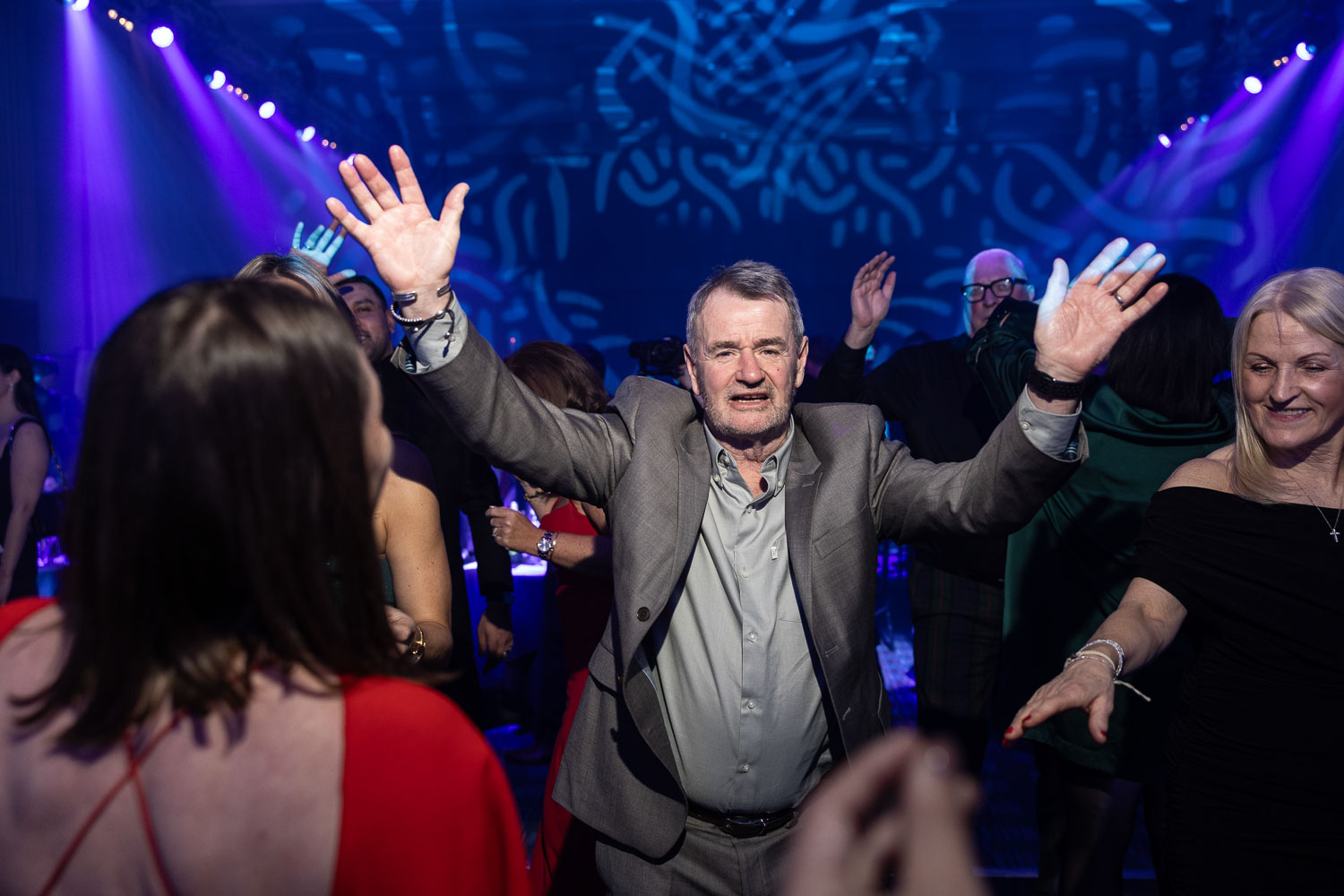 julie mcknight entertaining the guests at a charity dinner