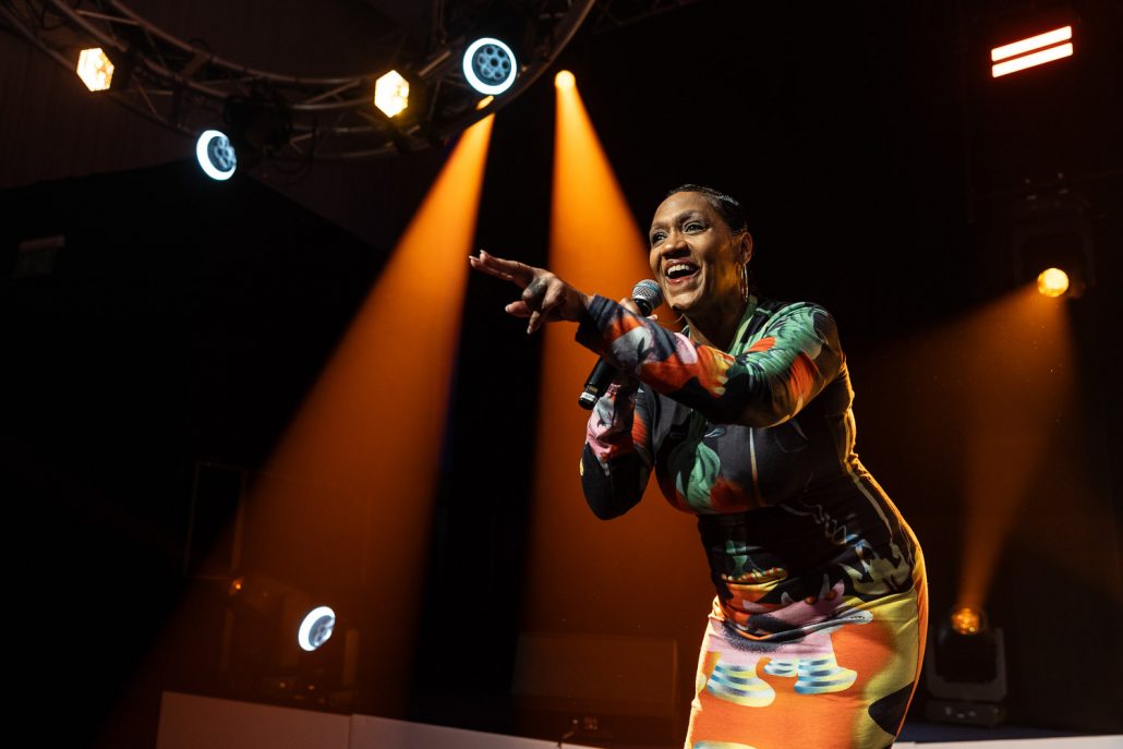 julie mcknight entertaining the guests at a charity dinner