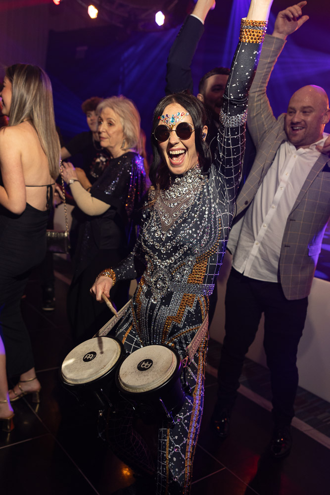 julie mcknight entertaining the guests at a charity dinner