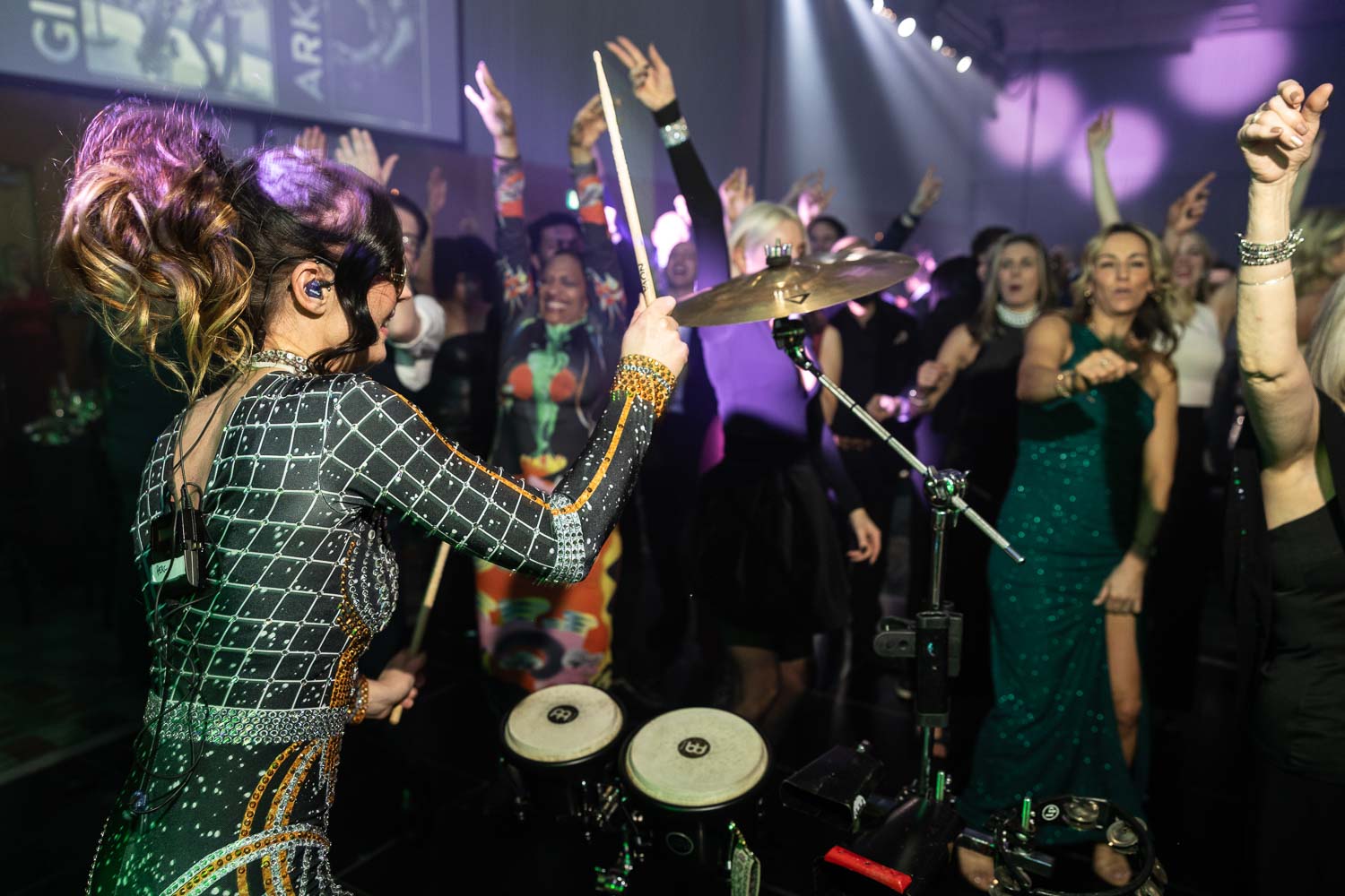 julie mcknight entertaining the guests at a charity dinner
