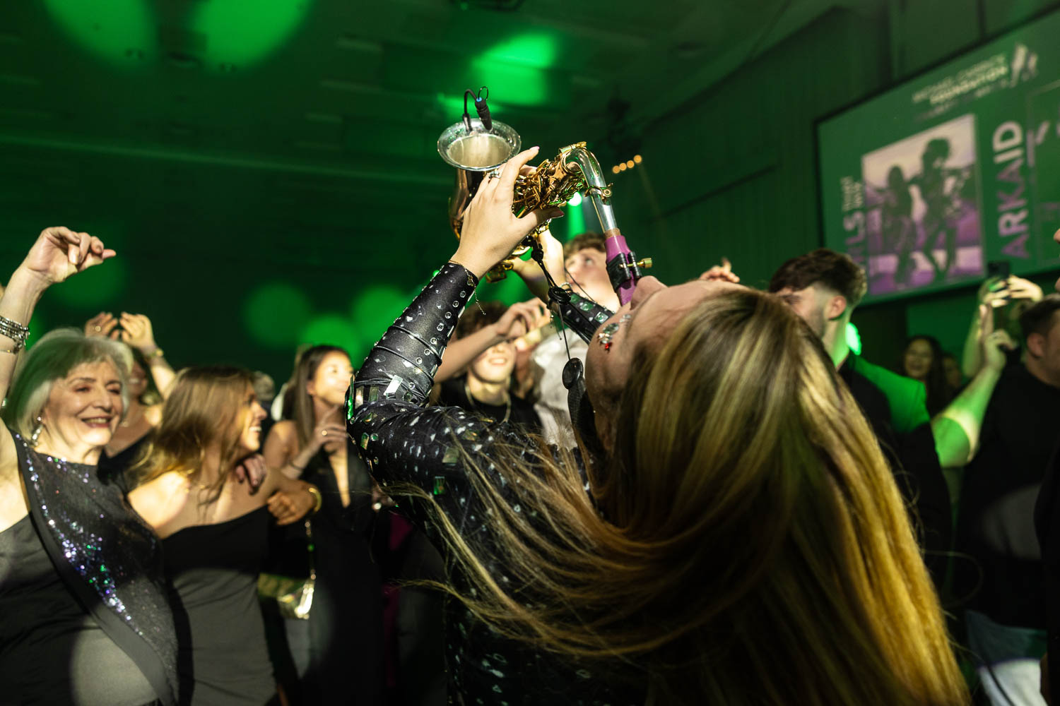 julie mcknight entertaining the guests at a charity dinner