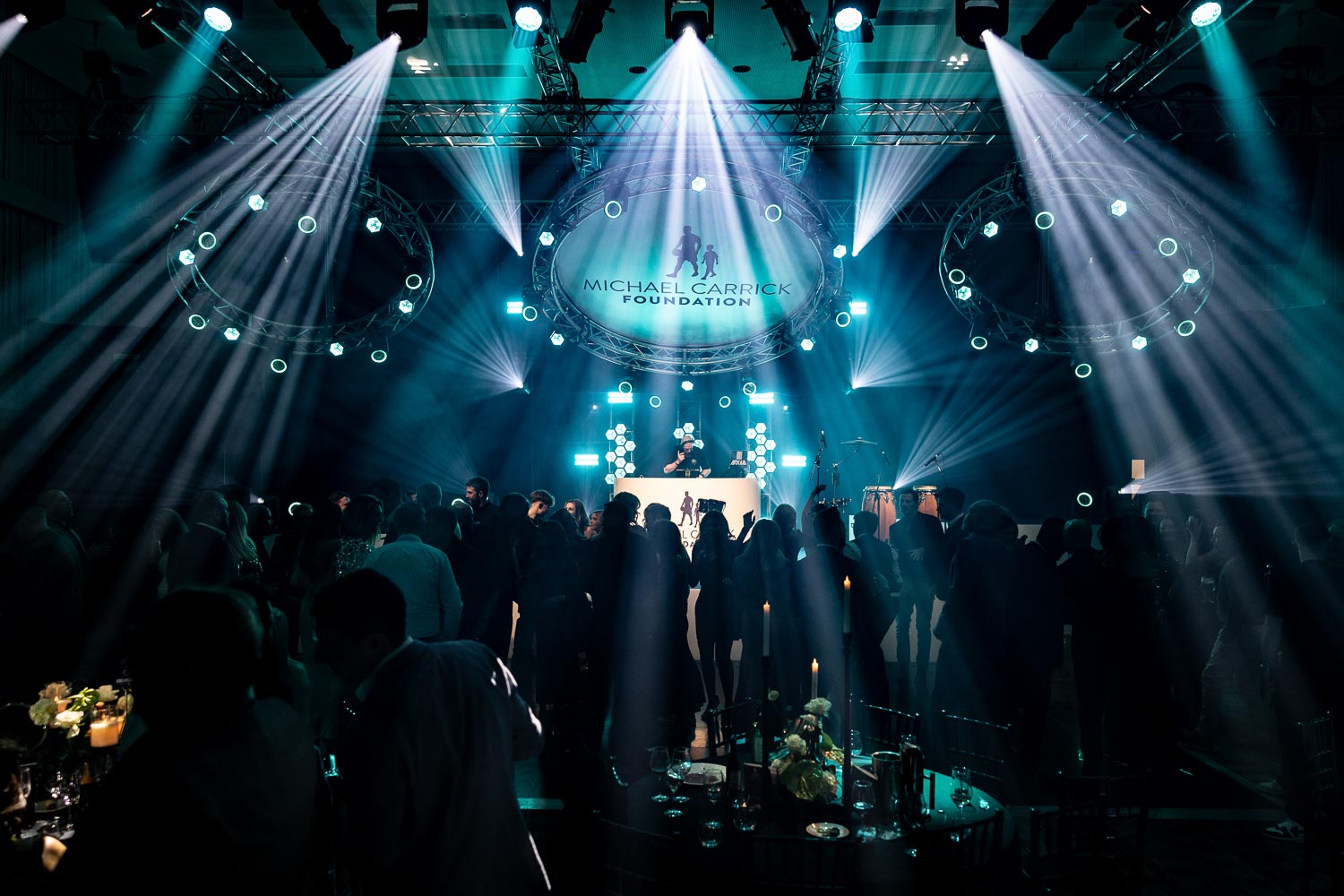 julie mcknight entertaining the guests at a charity dinner