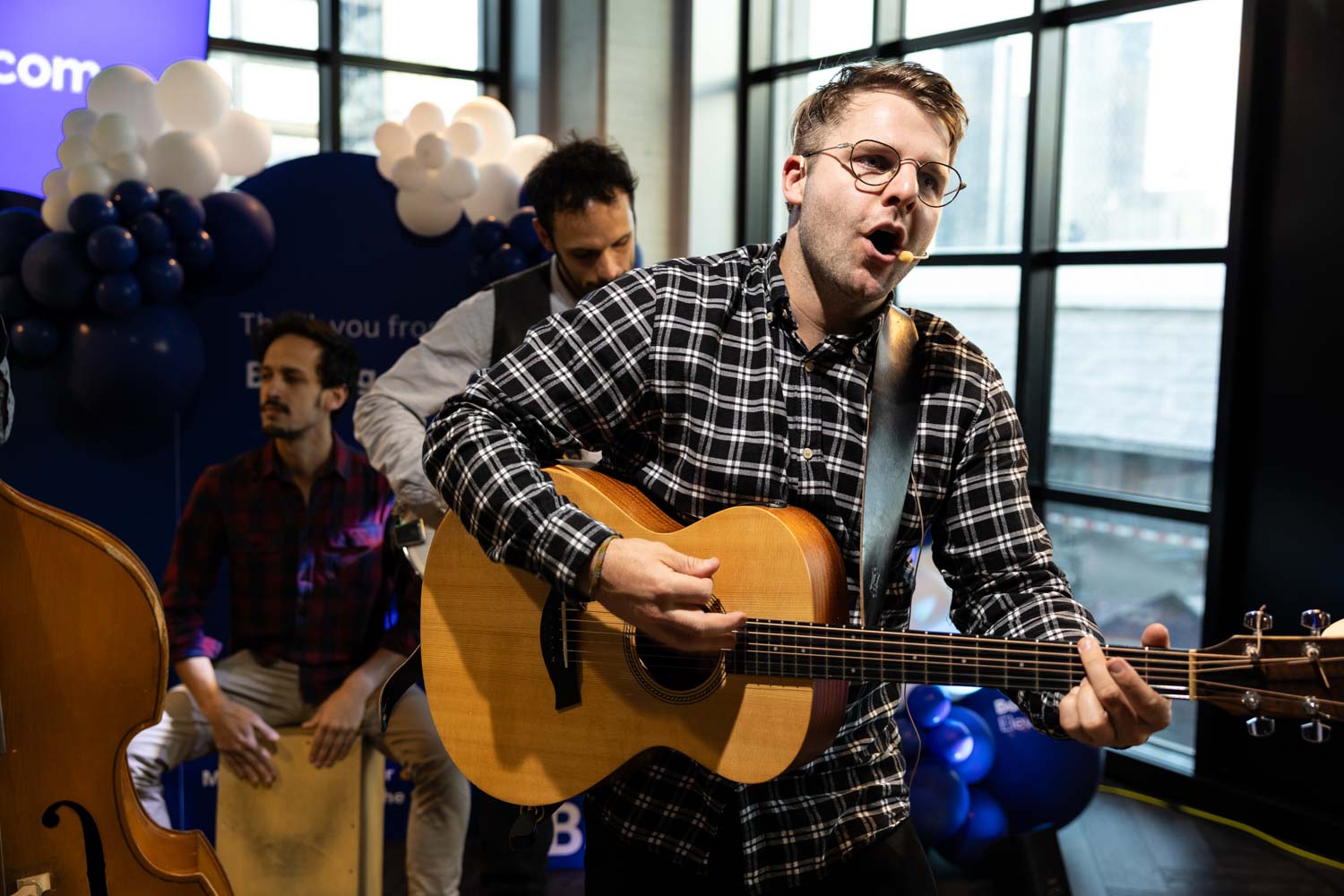 Acoustic musicians performing during the Booking.com Elevate networking event at the Manchester campus