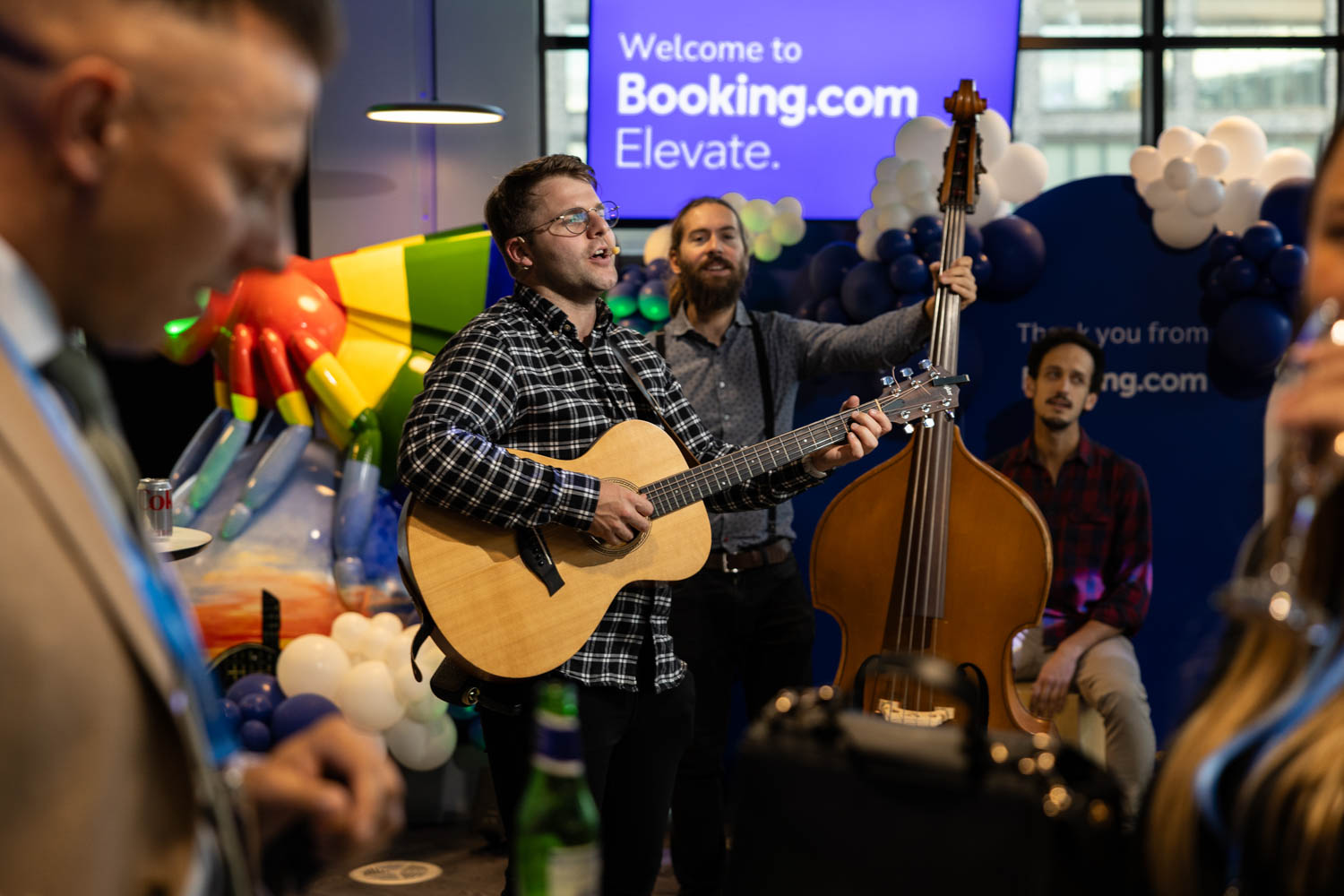 Acoustic musicians performing during the Booking.com Elevate networking event at the Manchester campus