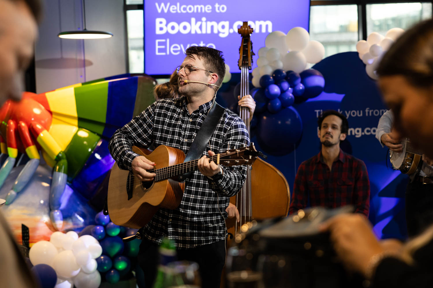 Acoustic musicians performing during the Booking.com Elevate networking event at the Manchester campus