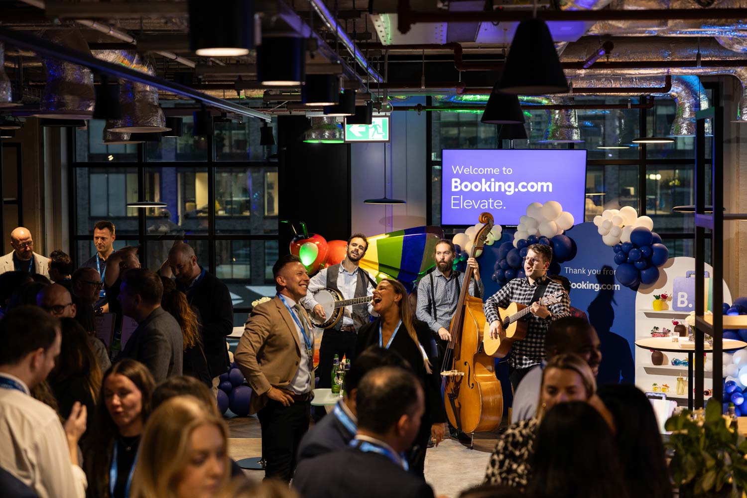 Acoustic musicians performing during the Booking.com Elevate networking event at the Manchester campus