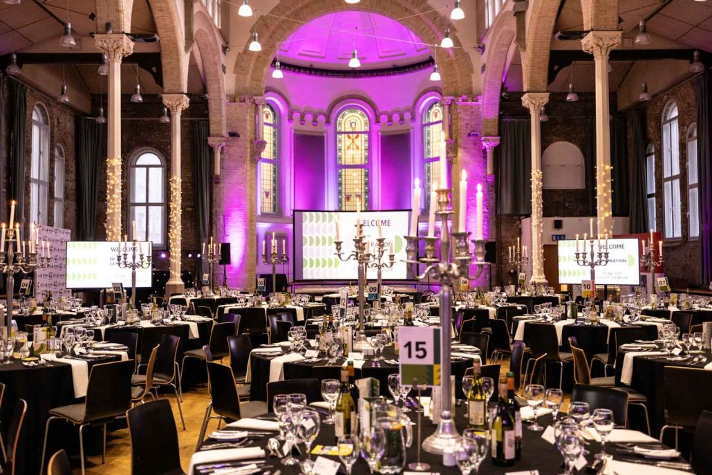 Commercial Interior Next Gen Awards venue setup with candlelit tables and purple lighting captured by Event Photographer Manchester.
