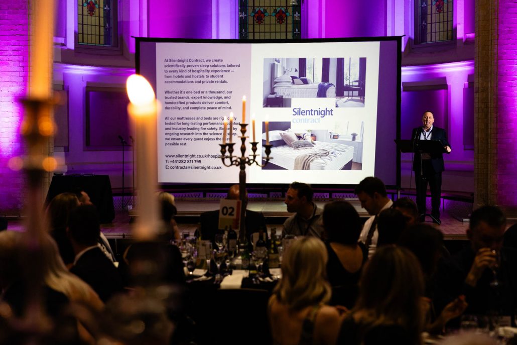 Commercial Interior Next Gen Awards venue setup with candlelit tables and purple lighting captured by Event Photographer Manchester.