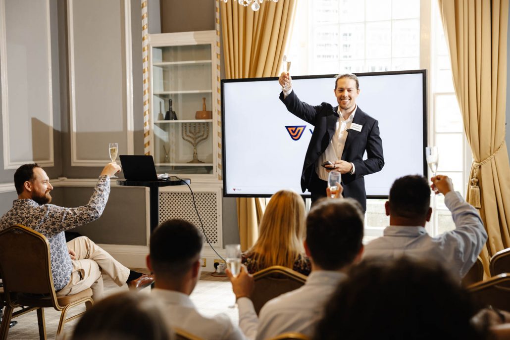 Business speaker raising a toast with audience at Manchester conference event, Conference Photographer Manchester