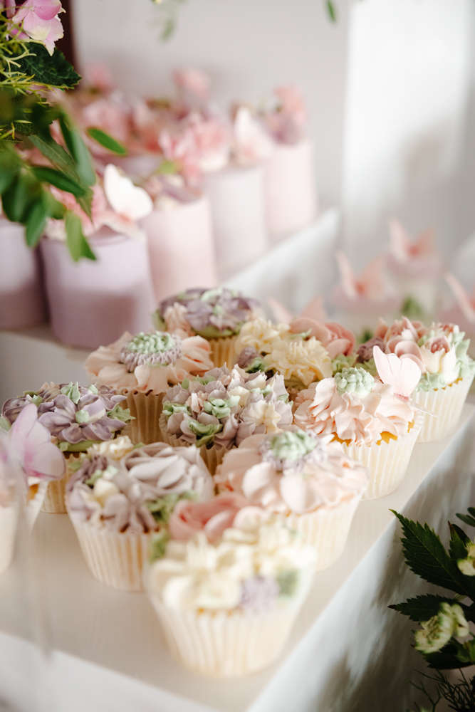 Pink sparkling drinks in champagne flutes with floral garnish at a stylish birthday party in Manchester