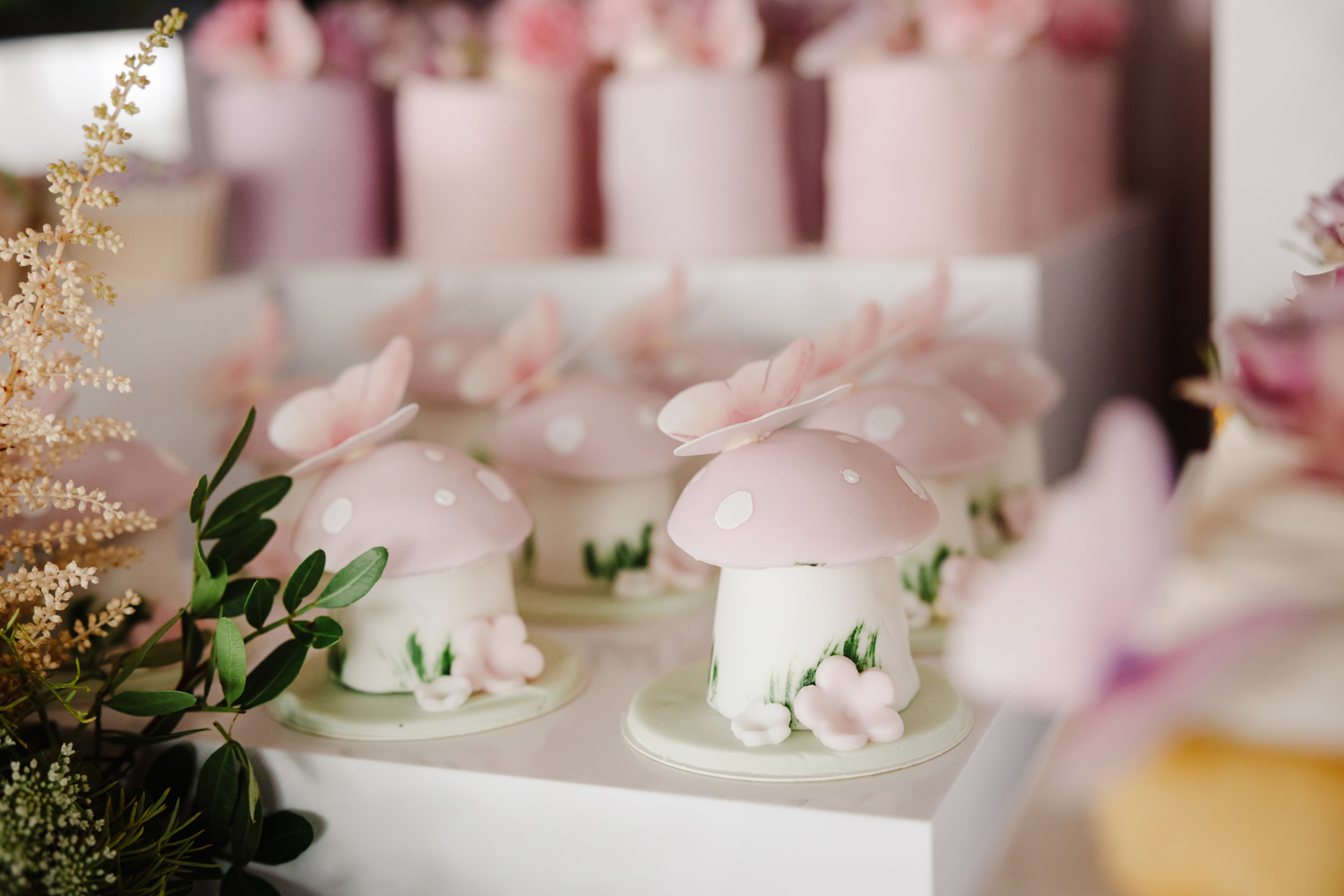 Pink sparkling drinks in champagne flutes with floral garnish at a stylish birthday party in Manchester