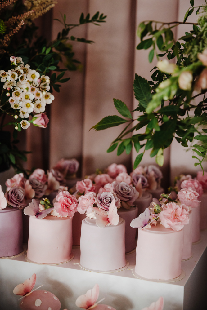 Pink sparkling drinks in champagne flutes with floral garnish at a stylish birthday party in Manchester