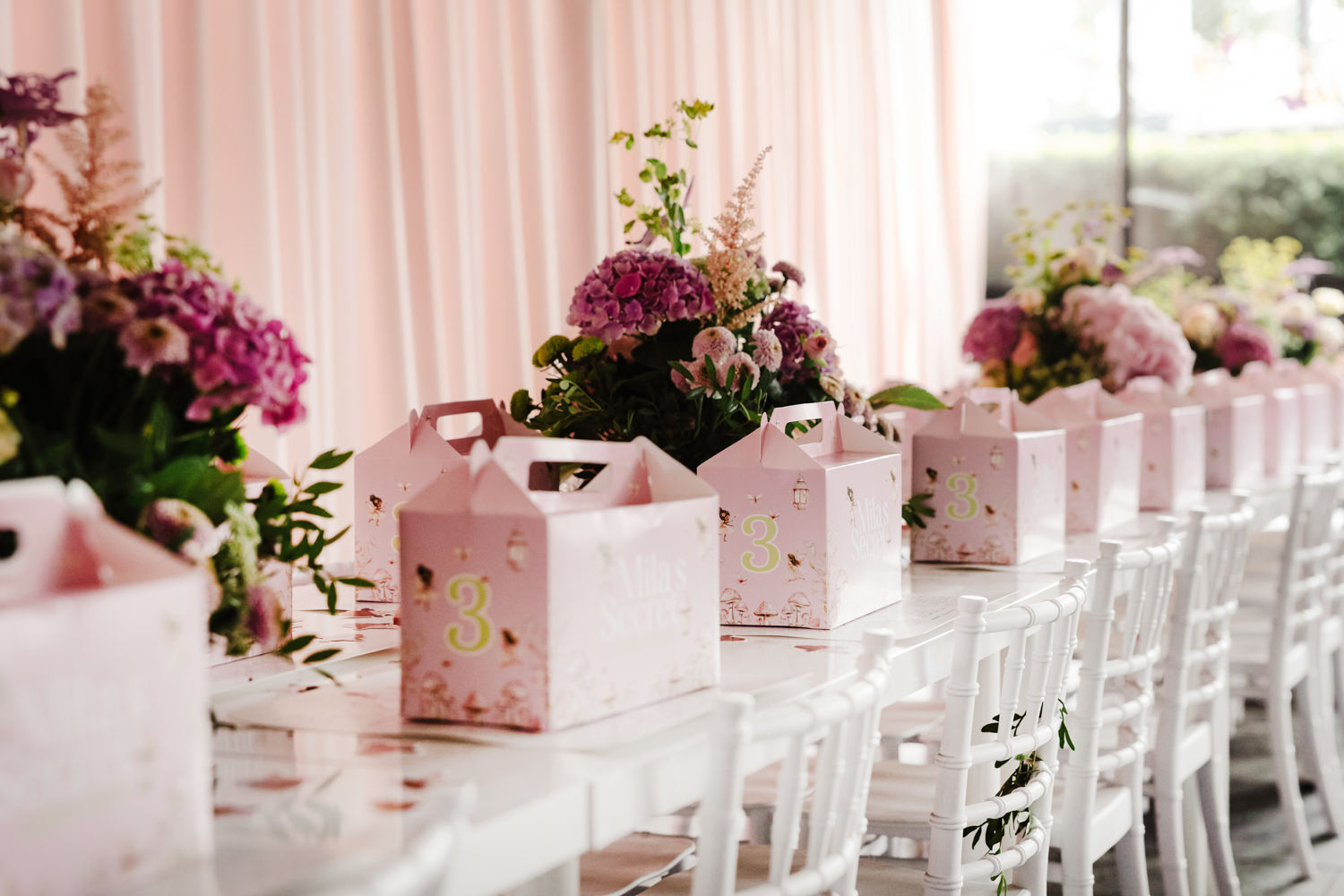 Beautifully styled dessert table with pink drinks, cupcakes, and floral decorations at a children’s birthday party in Manchester