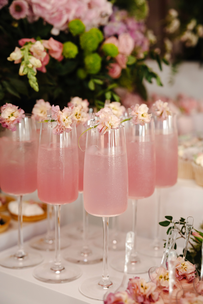 Floral arrangement in a vase with “The Colony” sign in the background at a Manchester event venue