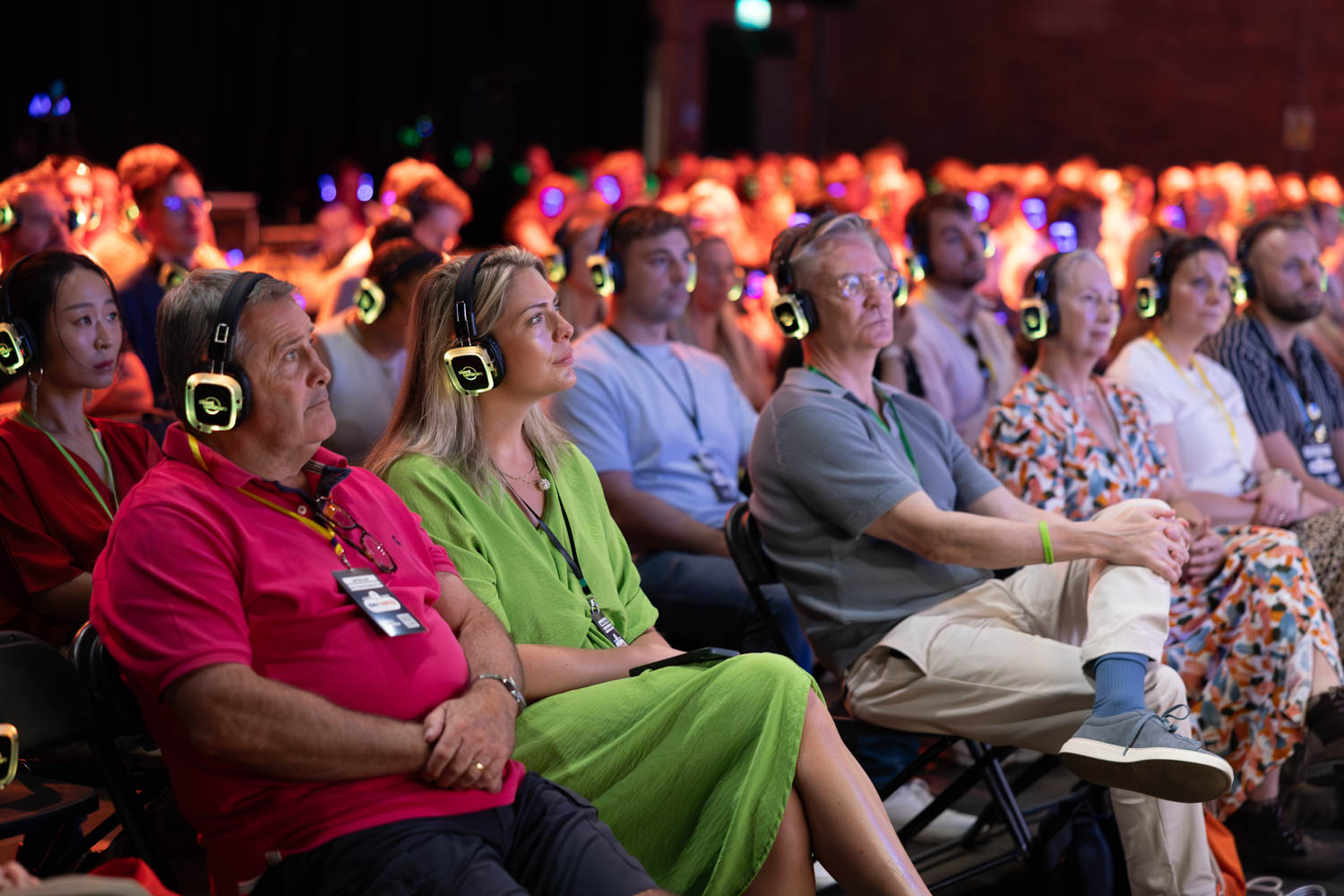 Audience wearing silent disco headphones listening to keynote talk at Plannex Conference, Conference Photographer Manchester