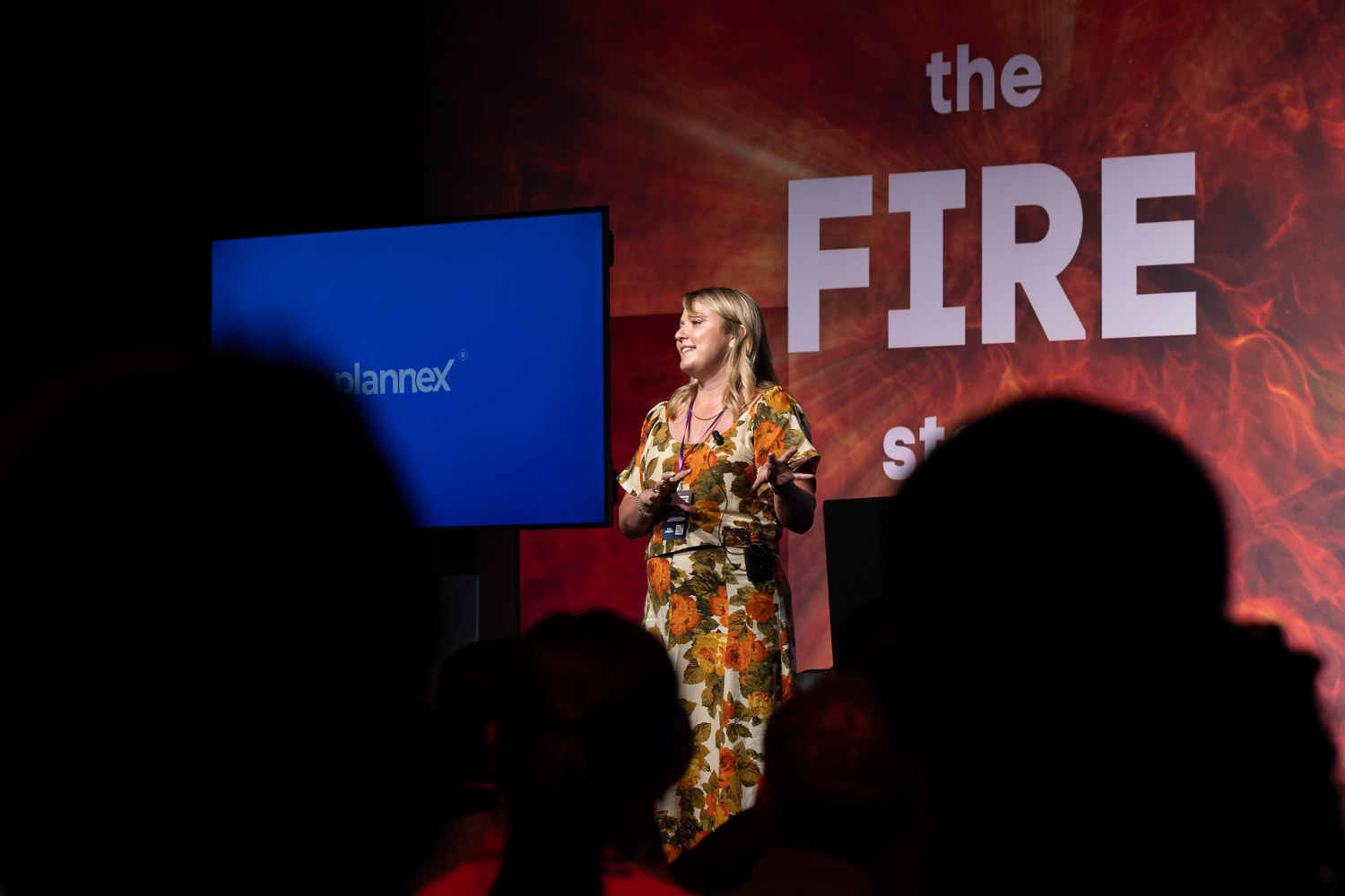 Speaker presenting on stage with branded screen at Plannex Conference in Manchester, Conference Photographer Manchester