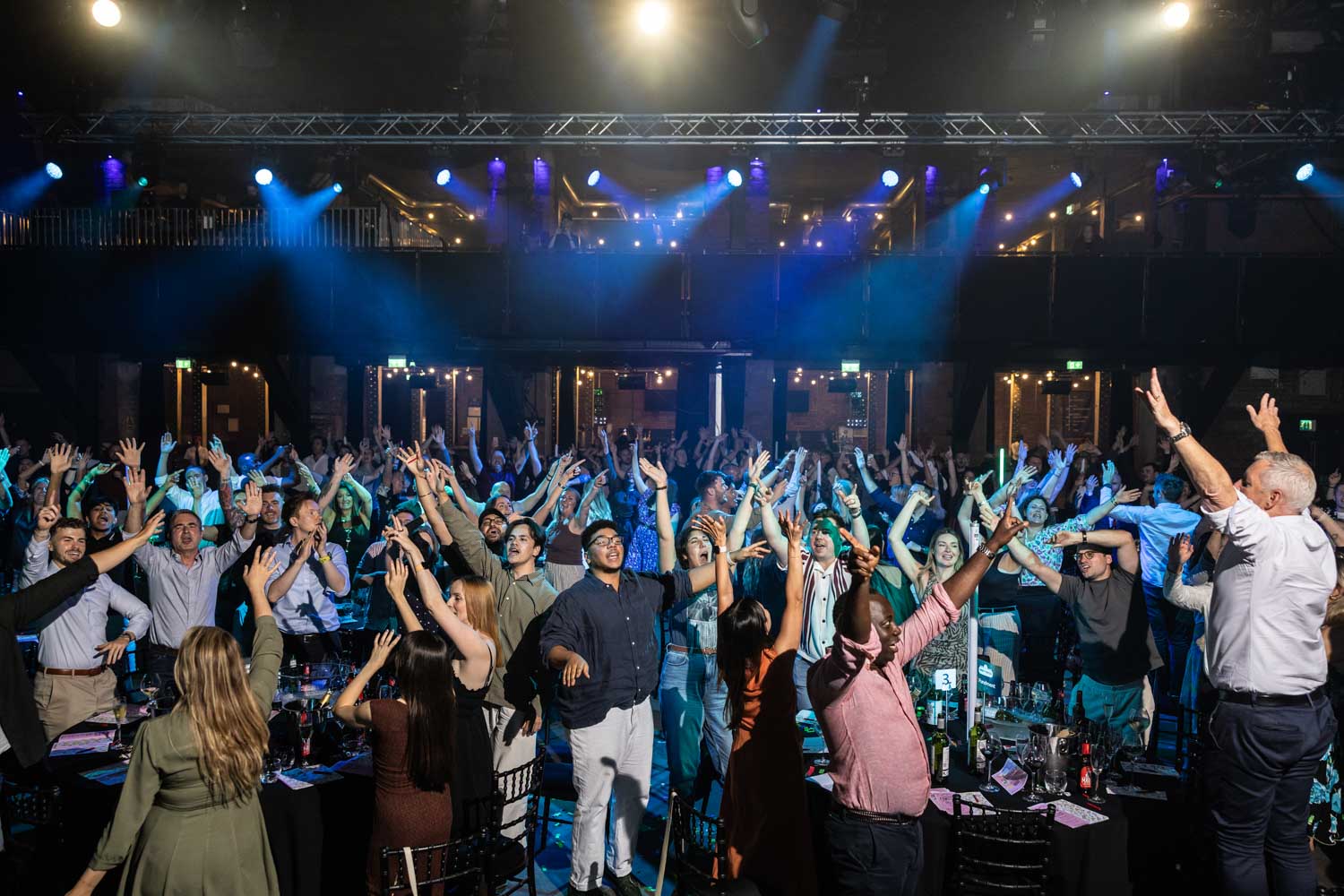 Conference Photographer Manchester capturing wide shot of packed dancefloor with guests celebrating at conference event