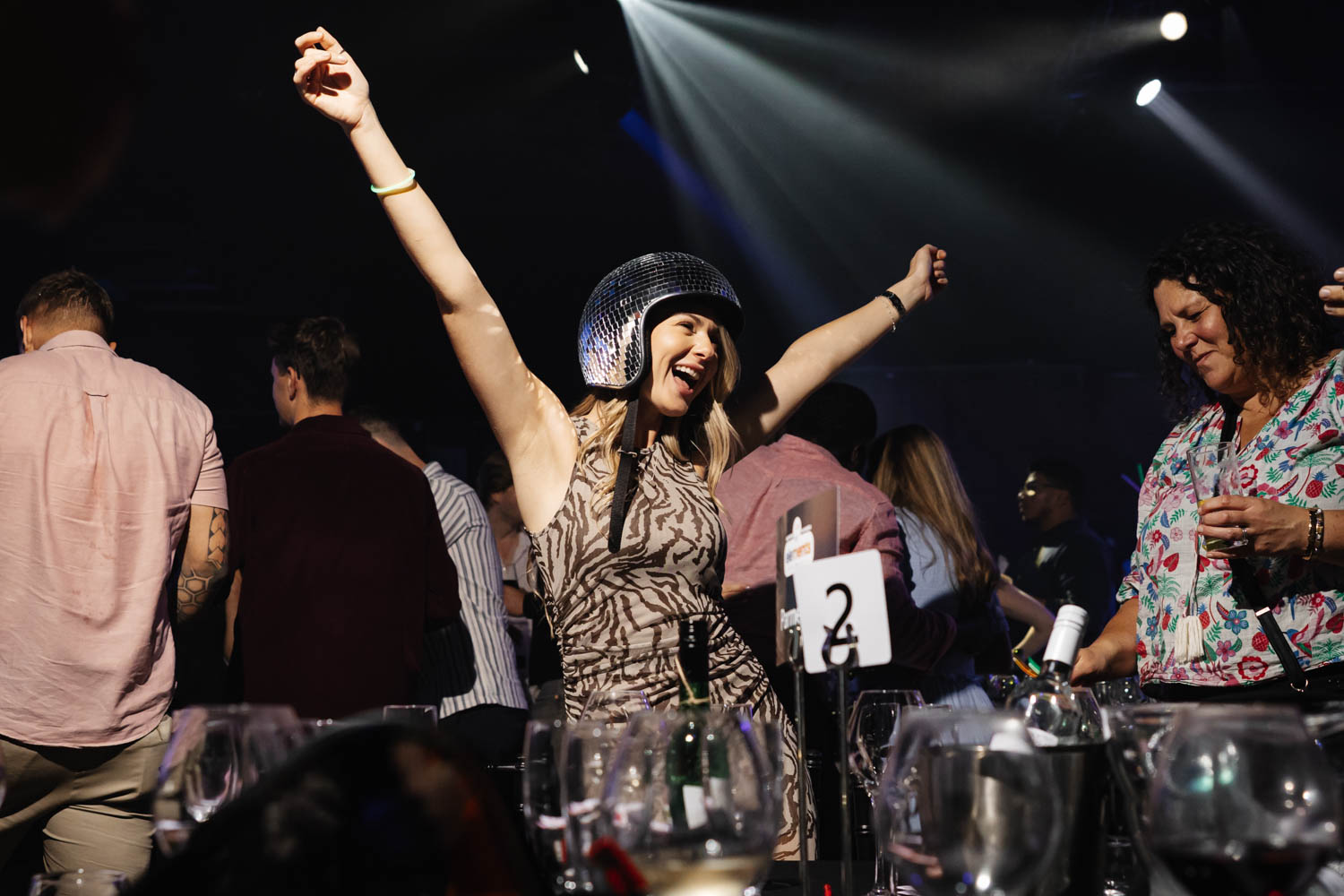 Conference Photographer Manchester capturing guest celebrating on dancefloor wearing disco helmet at corporate event