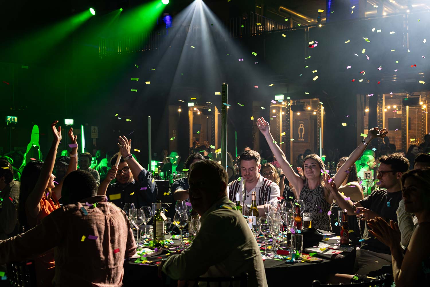 Conference Photographer Manchester capturing confetti moment with guests cheering at lively conference evening