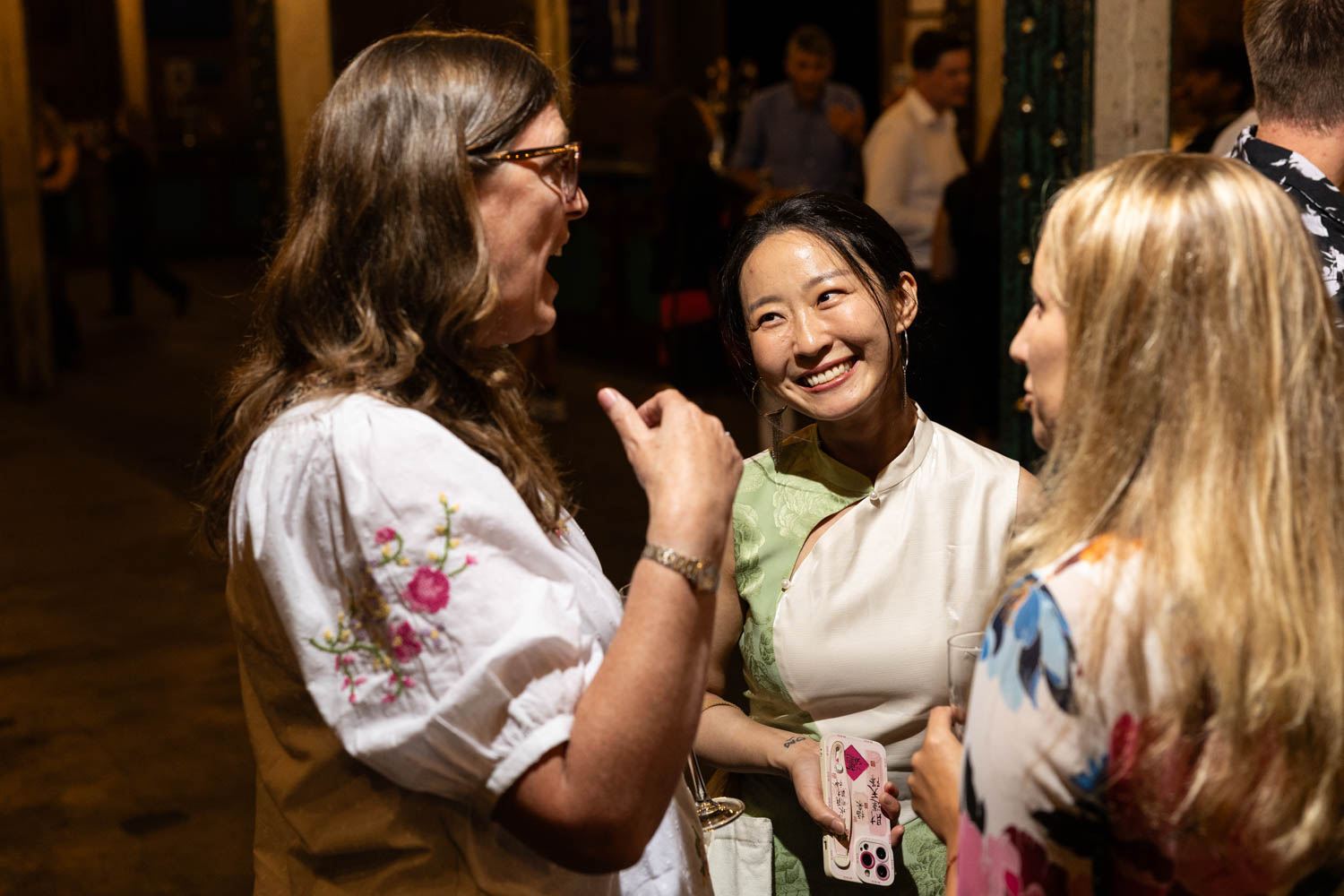 Conference Photographer Manchester capturing candid networking moment between guests at evening event