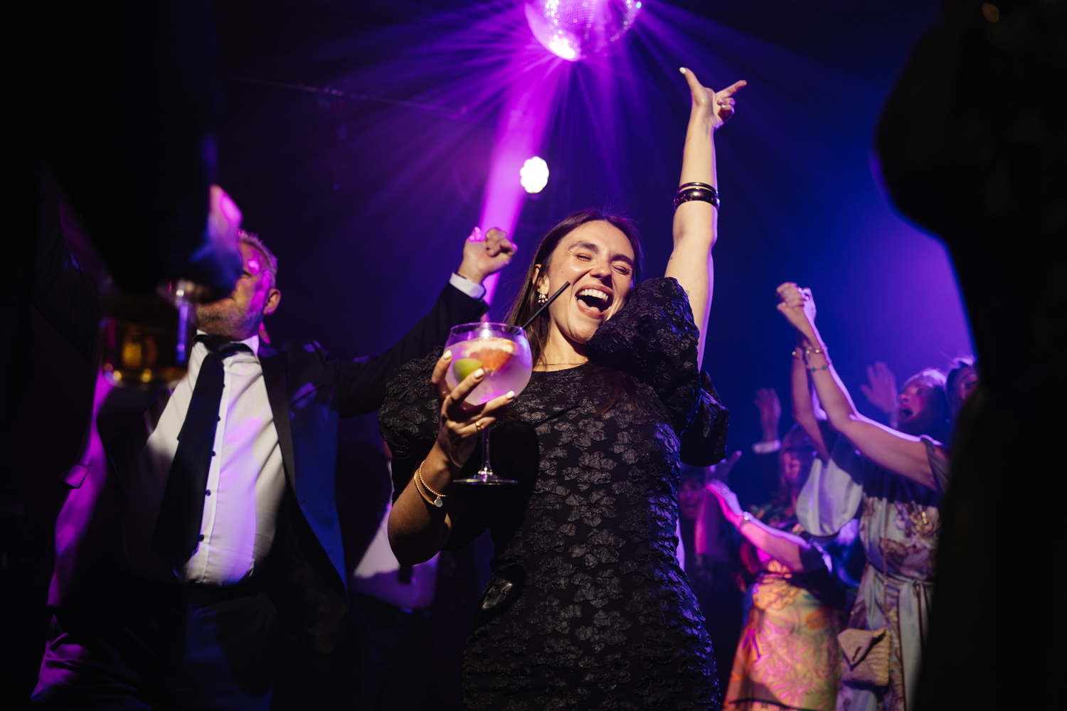 Guests dancing under disco lights at a 60th birthday party, captured by Birthday Party Photographer Cheshire