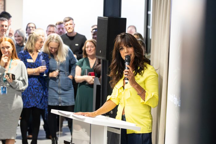 Guest speaker addressing attendees during the TGG office opening celebration event