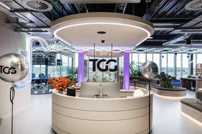 Guest speaker addressing attendees during the TGG office opening celebration event